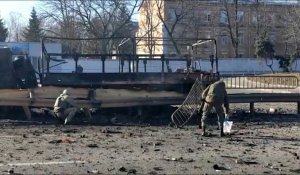 Des soldats ukrainiens ramassent des débris dans une rue de Kiev après des frappes aériennes