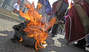 Des manifestants brûlent le drapeau français devant l'ambassade à La Paz