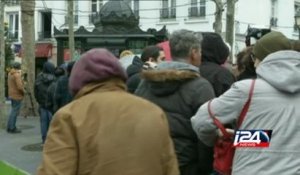 People line up to buy the latest issue of Charlie Hebdo in France