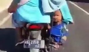 Ils transportent leur enfant dans le porte bagage de leur moto