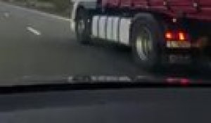 Un migrant perce la bâche d'un camion sur l'autoroute E403