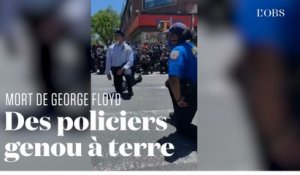 Des policiers posent le genou à terre en soutien aux manifestants après la mort de George Floyd