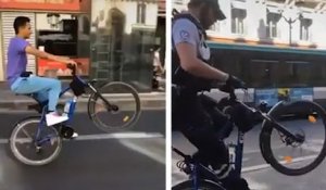 Un policier tente une roue arrière sur son vélo