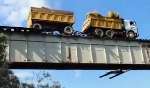 Au volant de son camion il traverse  un pont ferroviaire... en roulant sur les rails